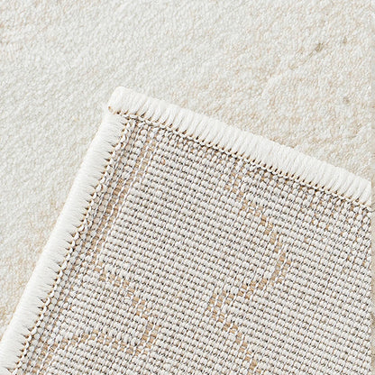 Back view of cream abstract area rug showing durable woven backing and edge finish