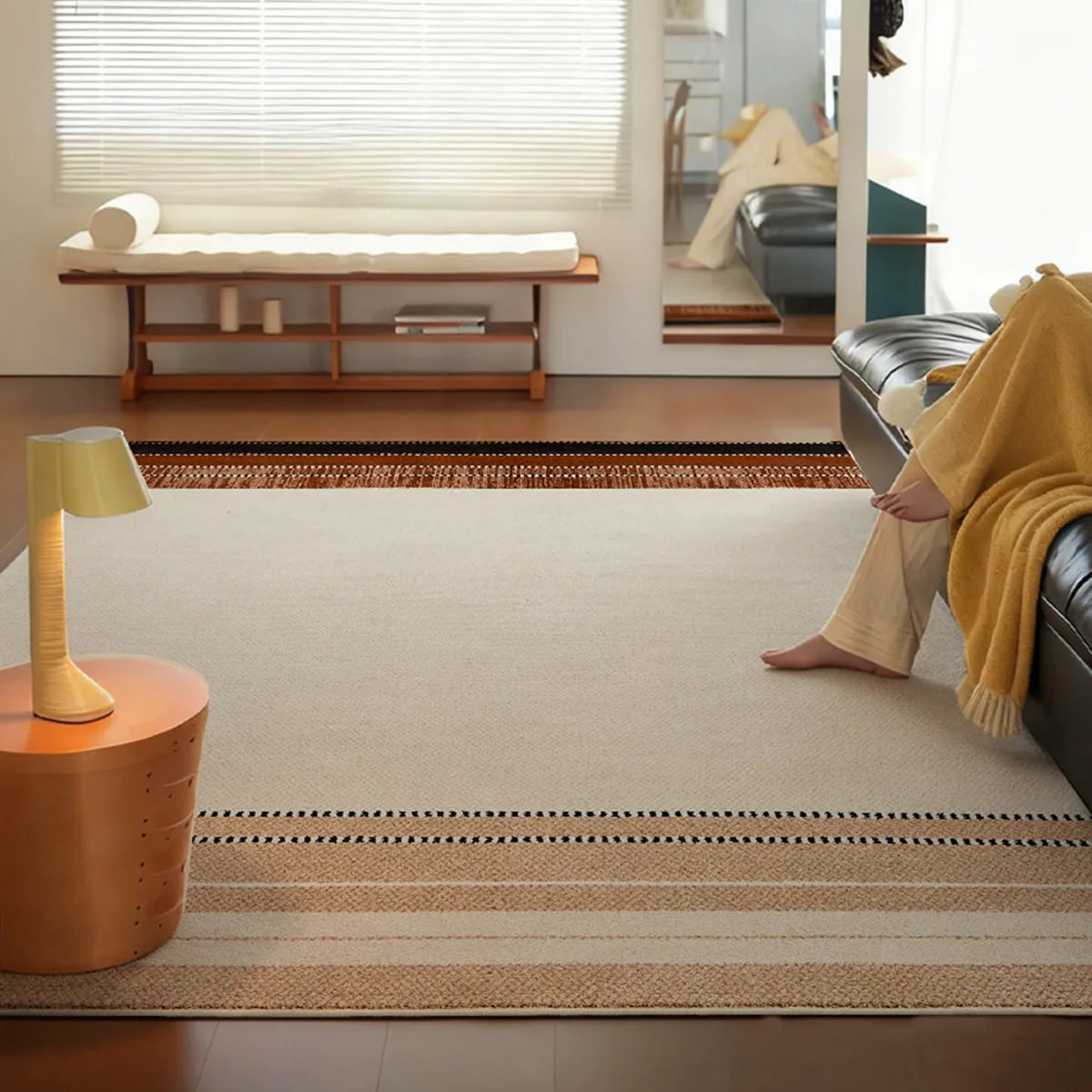 Large cream beige border rug in a modern living room with warm neutral decor