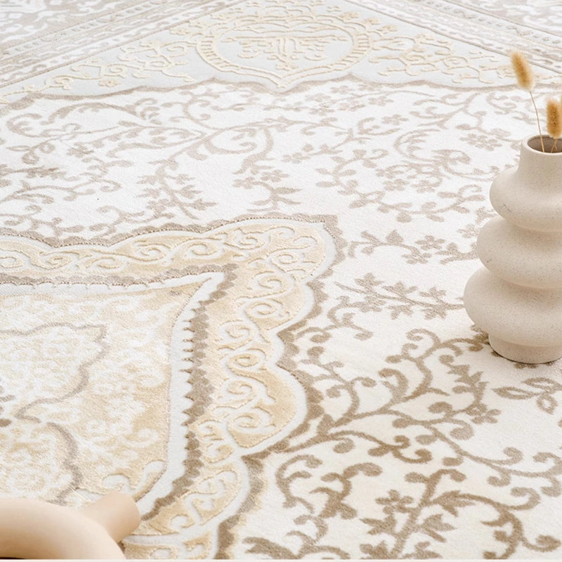 Cream beige Persian rug detail showing the medallion pattern, traditional border, and textured woven surface