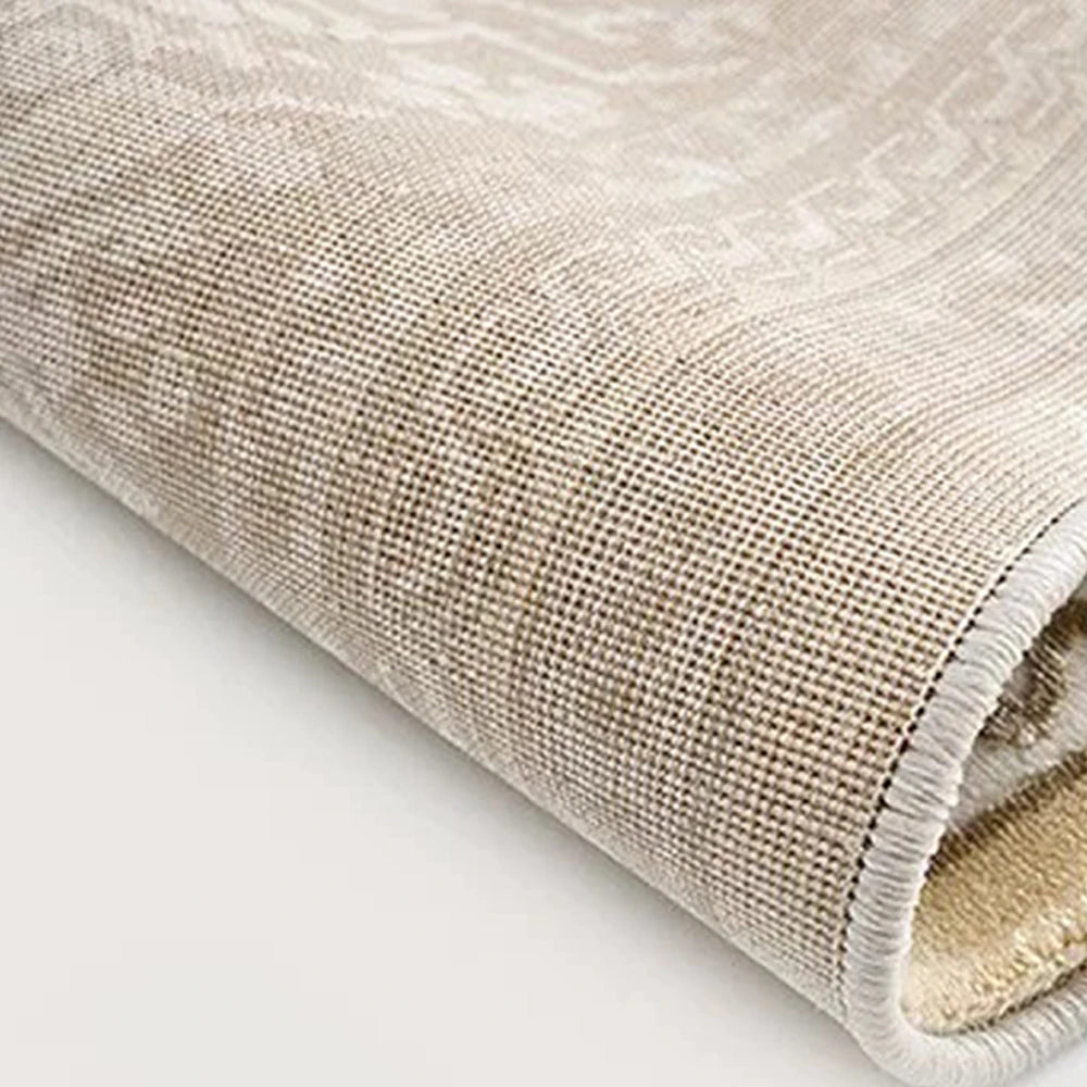 Back of a cream beige Persian area rug showing the tightly woven backing for everyday stability.
