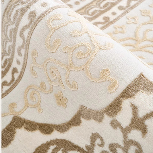 Cream beige Persian rug close-up showing raised traditional patterns and textured woven surface