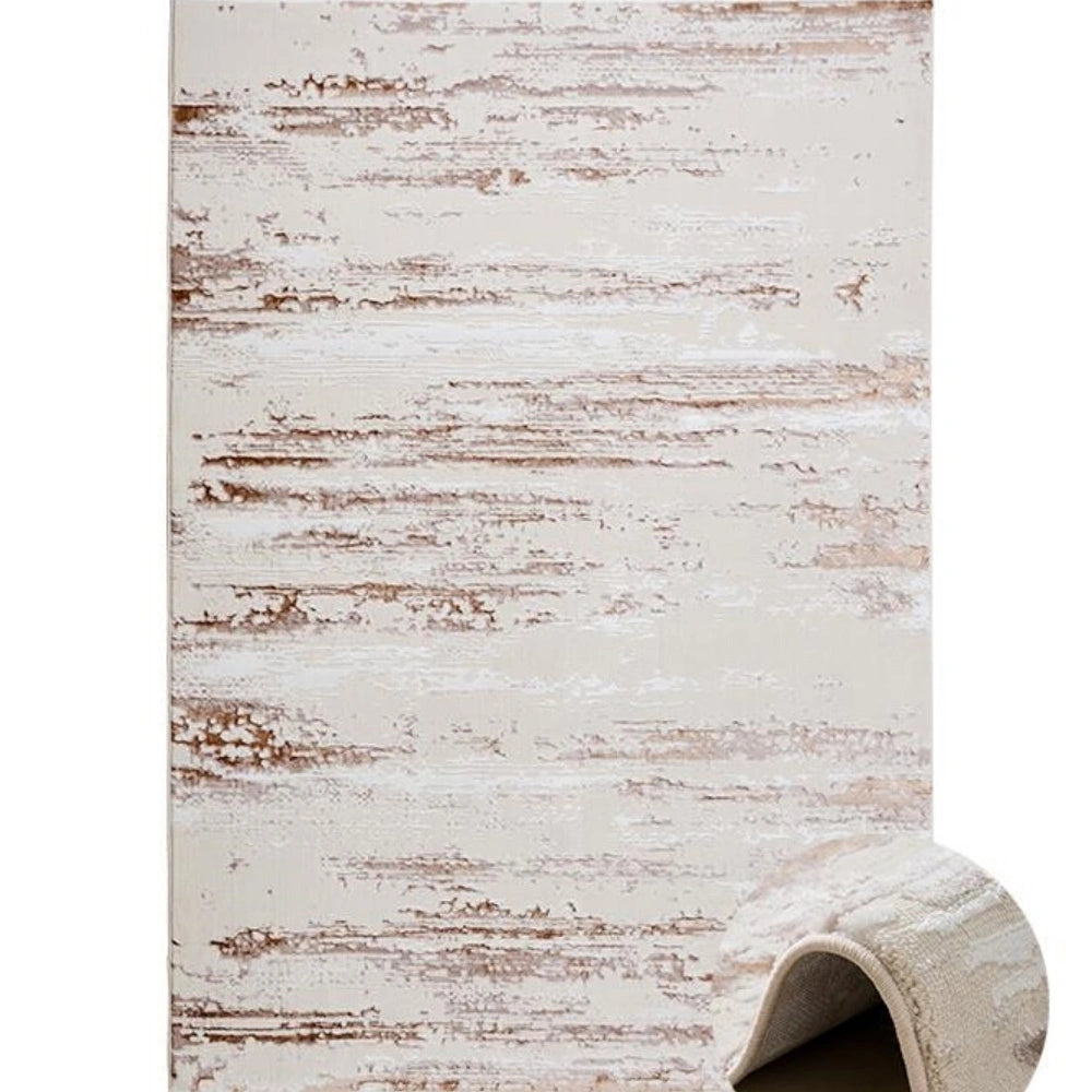 Full view of cream brown distressed abstract area rug with soft neutral base and brown distressed lines