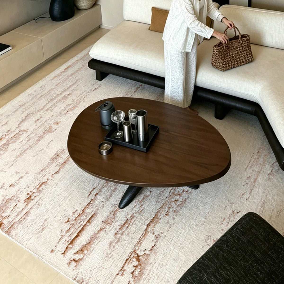 Cream brown distressed abstract area rug styled in a modern living room with a round coffee table