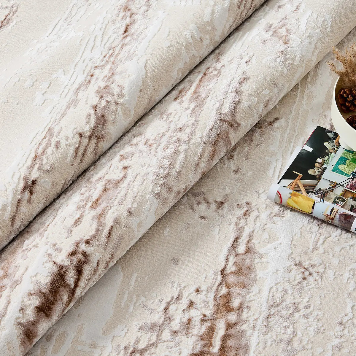 Rolled detail of ivory rust brown distressed abstract area rug showing soft pile and weathered pattern