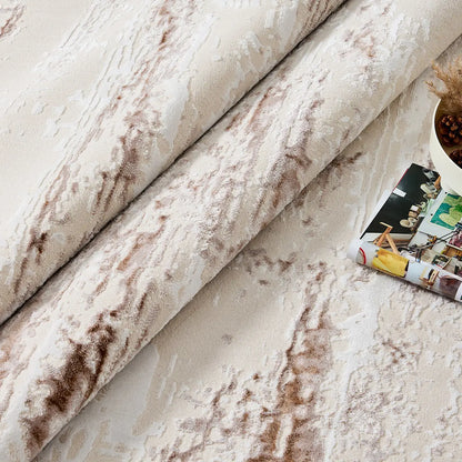 Rolled detail of ivory rust brown distressed abstract area rug showing soft pile and weathered pattern