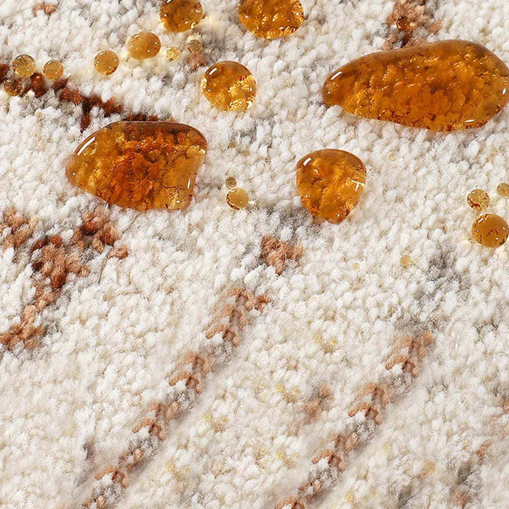 Cream brown distressed abstract area rug with spill-resistant surface showing liquid beads on the textured pile