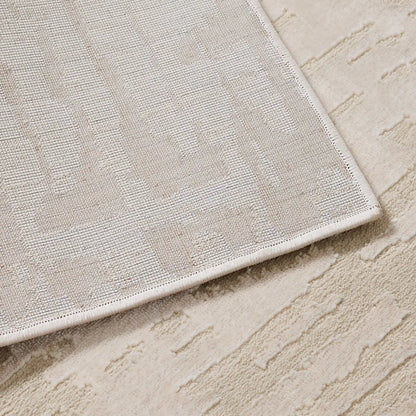 backing structure of cream area rug showing woven base and reinforced edges