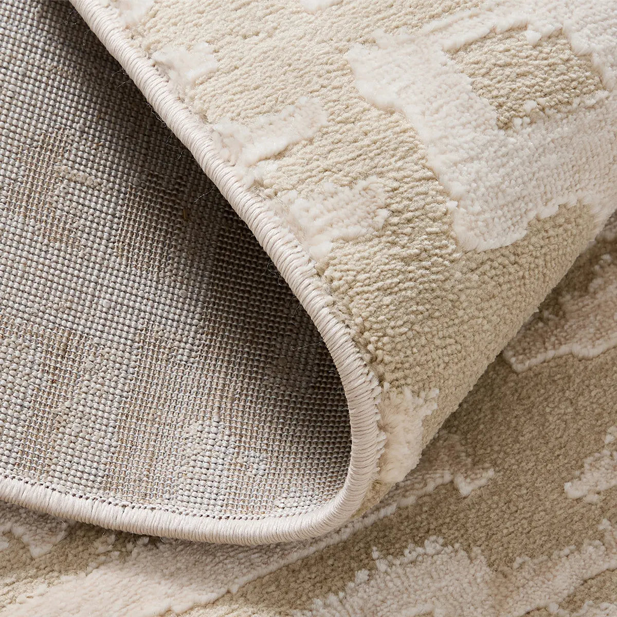 cream area rug with durable jute backing and reinforced edge detail