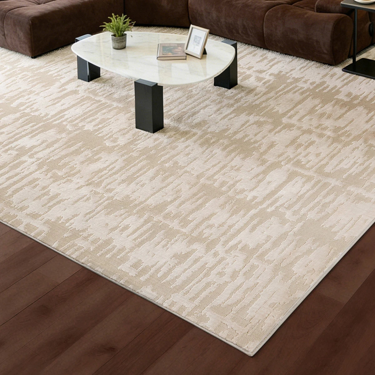 cream textured area rug under a coffee table in a modern living room with warm wood flooring