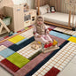 Baby girl smiling on a colorful geometric rug in nursery playroom, playing with wooden toys.