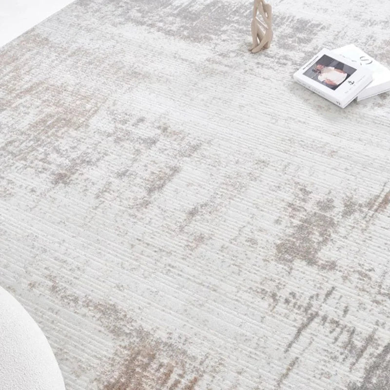 Close-up of gray abstract rug texture with a distressed finish, highlighting modern minimalist design