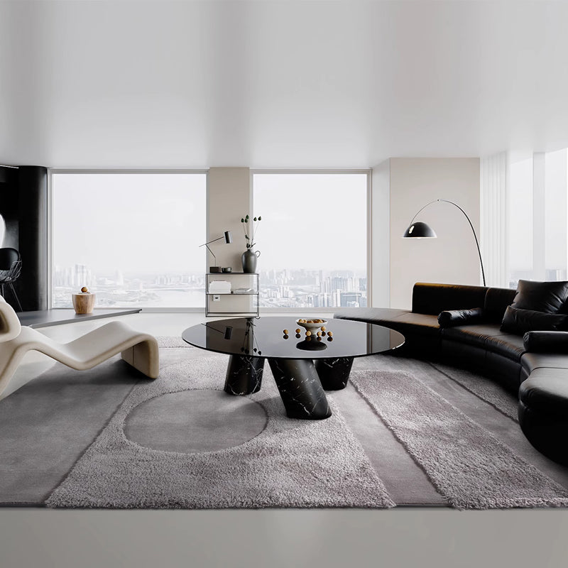 Large gray rug in a modern living room with a black leather sofa, marble coffee table, and city view #Shape_Rectangle