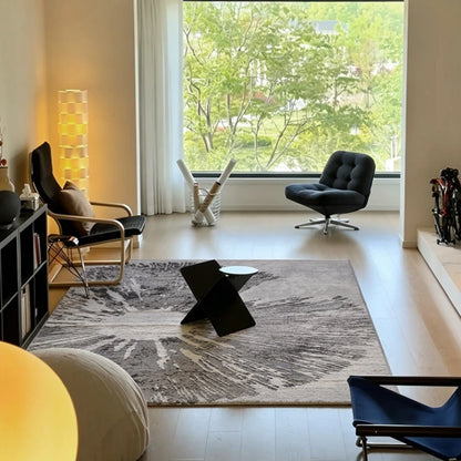 Grey abstract burst area rug styled in a modern window room with a neutral contemporary interior