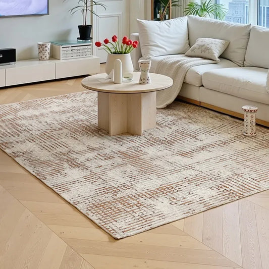 Cream geometric Italian rug in a modern living room, styled with a white sofa, natural wood floor, and soft daylight