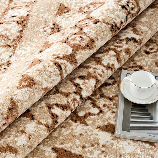 Ivory beige abstract area rug rolled up to show soft pile and flexible construction