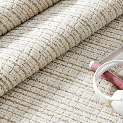 Rolled close-up of an ivory cut and loop grid area rug showing raised wool blend texture