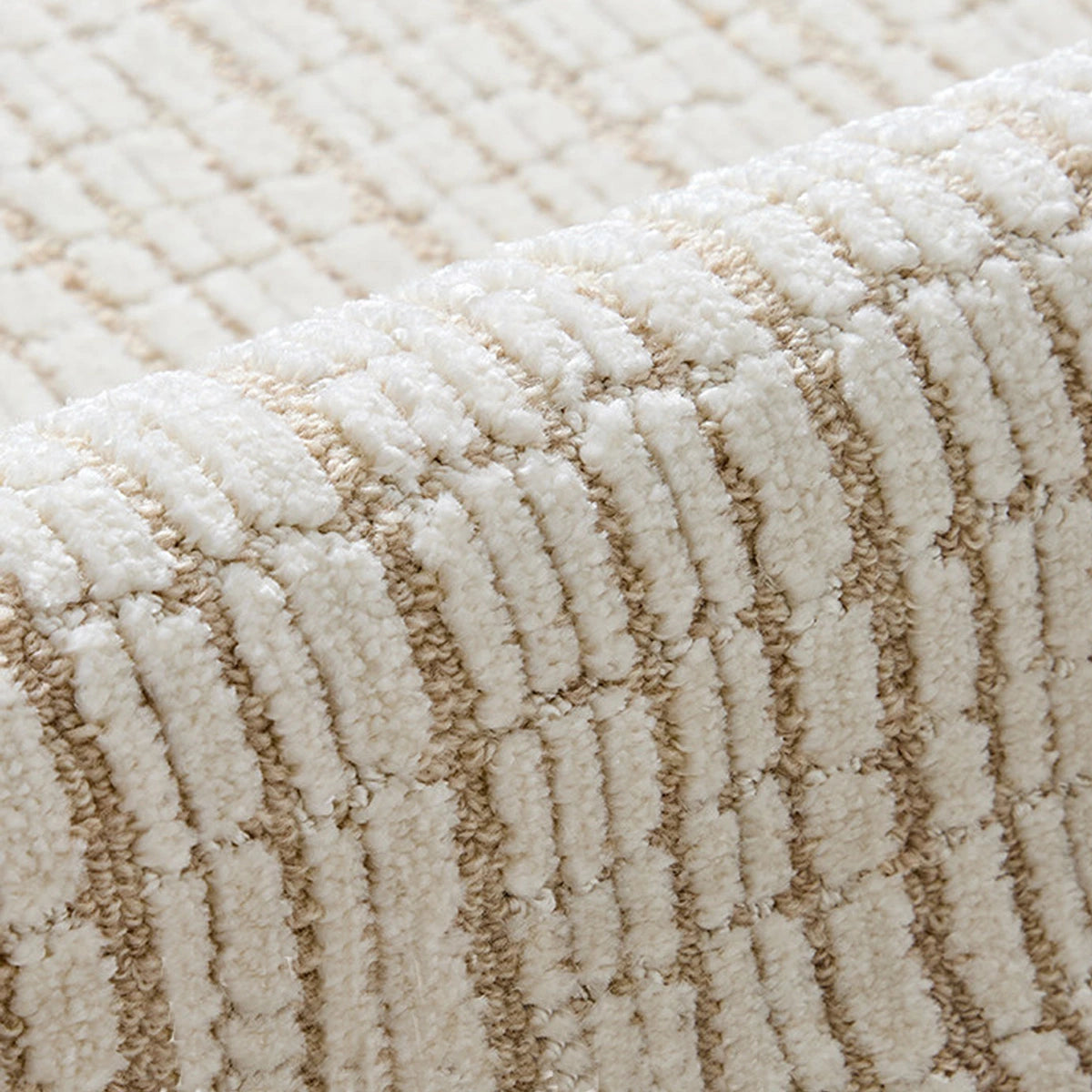 Close-up of a cream beige grid wool blend area rug showing high-low cut-and-loop texture