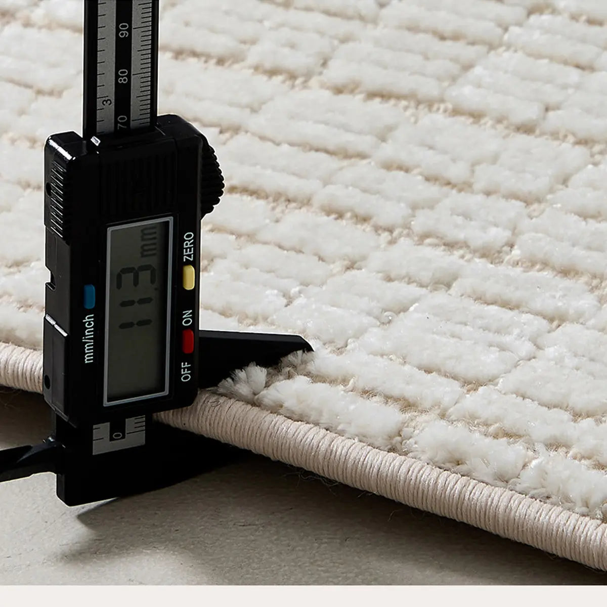Ivory cut and loop grid area rug showing approximately 11mm thick wool blend construction