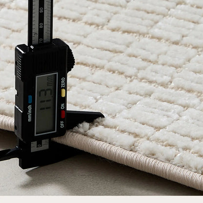 Ivory cut and loop grid area rug showing approximately 11mm thick wool blend construction