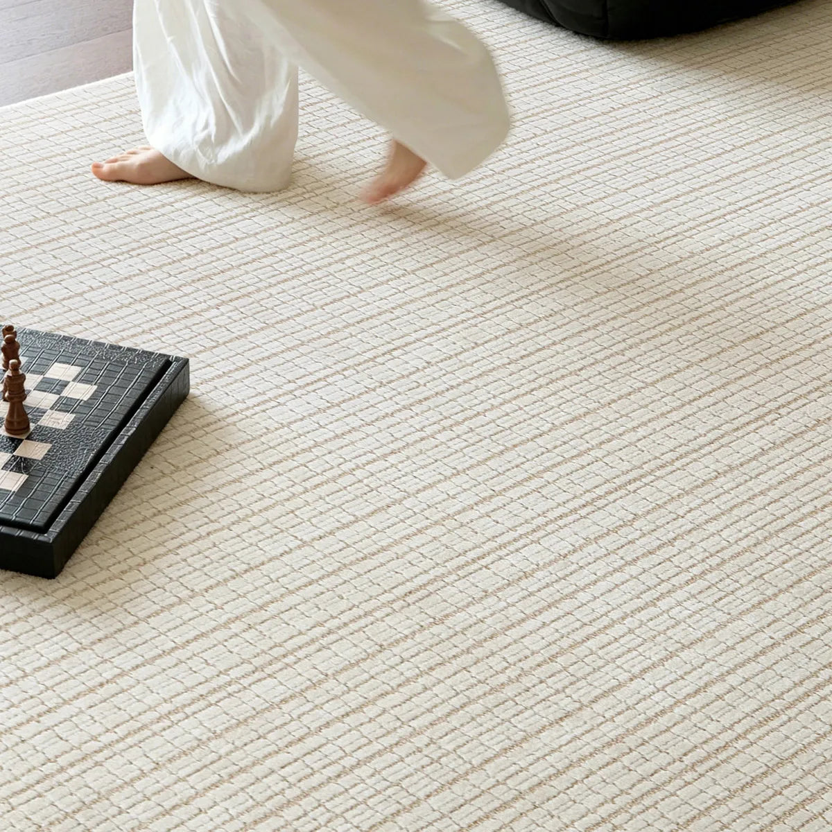 Ivory cut and loop grid area rug shown underfoot with a soft textured wool blend pile