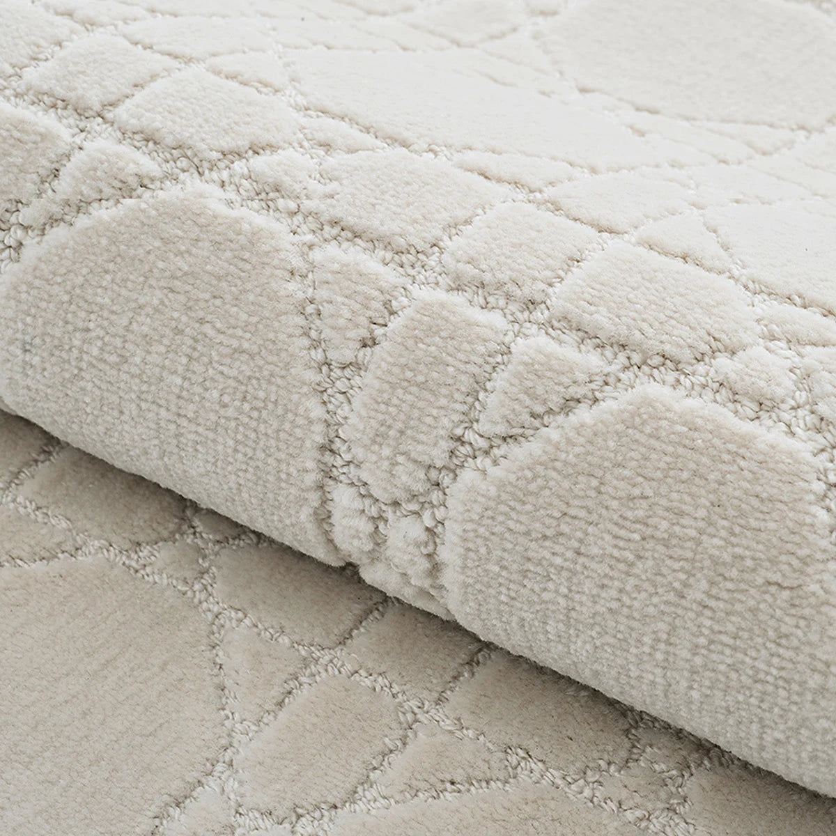 Ivory high-low geometric rug detail showing soft raised texture and thick woven construction