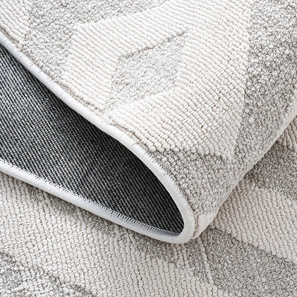Back view of an ivory grey textured area rug showing durable woven backing and reinforced edge binding