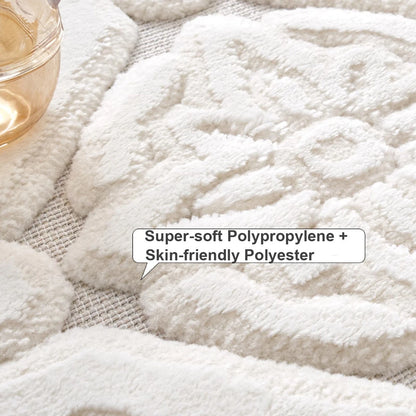 Close-up of an ivory raised floral medallion area rug with a soft polypropylene and polyester pile, sculpted high-low texture, and low woven base.