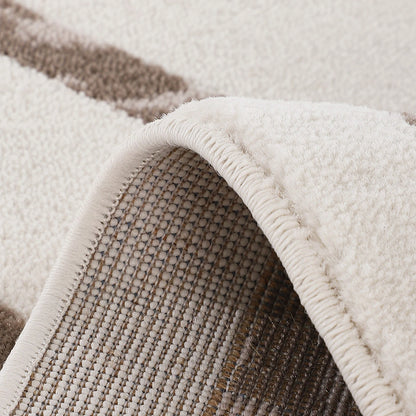 Ivory taupe abstract area rug showing woven backing and finished edge detail