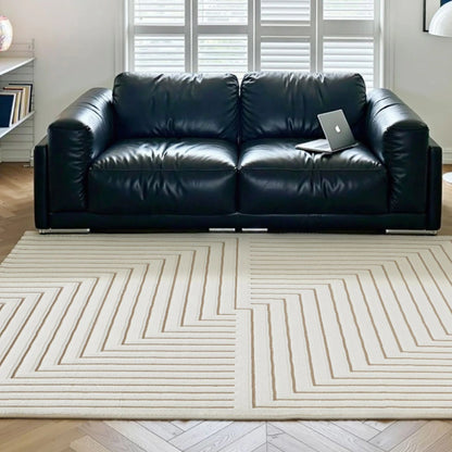 Ivory taupe geometric line area rug styled with a black sofa in a modern living room