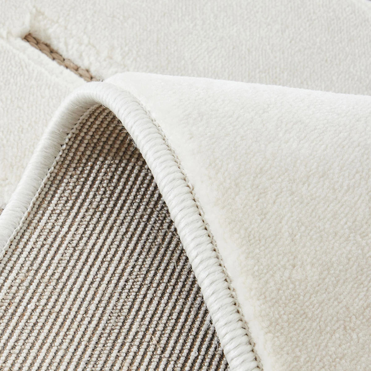 Ivory taupe geometric line rug with woven backing and bound edge close-up