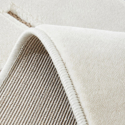 Ivory taupe geometric line rug with woven backing and bound edge close-up