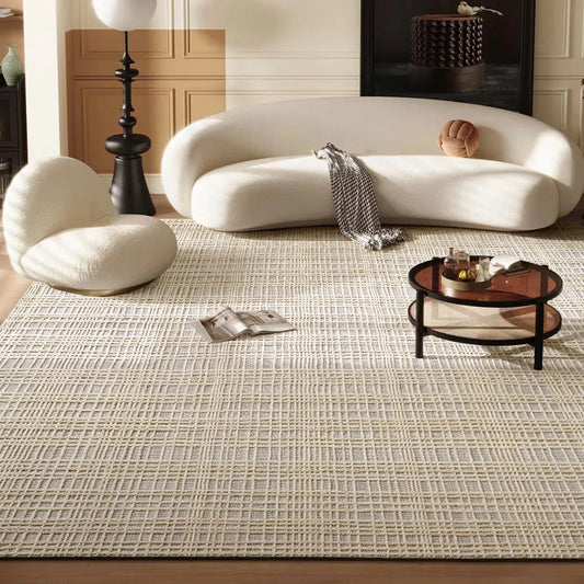 Ivory taupe high low grid area rug styled with a curved white sofa in a warm modern living room