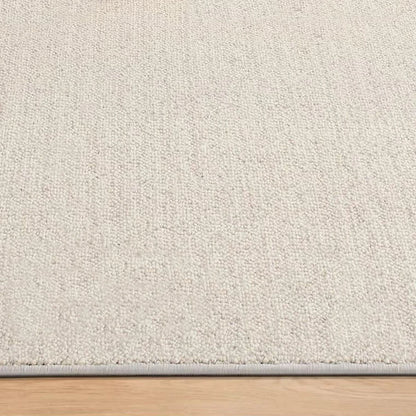 Ivory wool blend rug with a subtle tonal texture and dense high-low loop pile construction