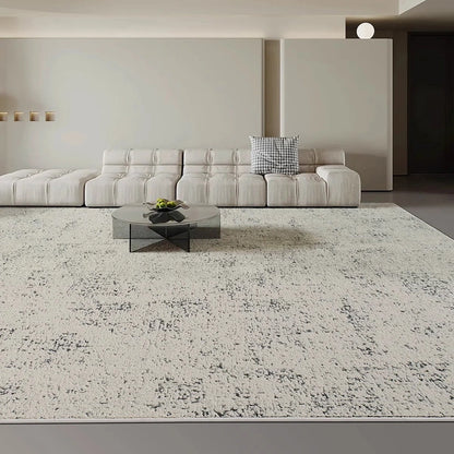 large gray area rug in a modern living room with minimalist sofa and open space layout