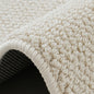 Close-up of loop pile wool rug showing textured surface and reinforced double-edge finish