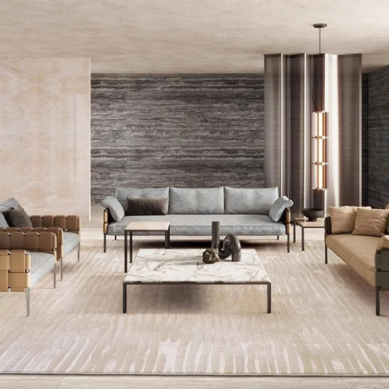 Luxury modern living room interior with beige wave-patterned area rug, contemporary sofas, marble coffee table, and elegant decor