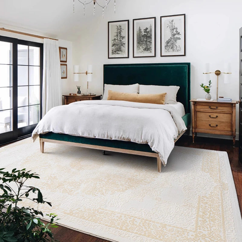 Luxury beige and gold Persian rug in a classic bedroom with a green velvet bed and wooden furniture #color_beige