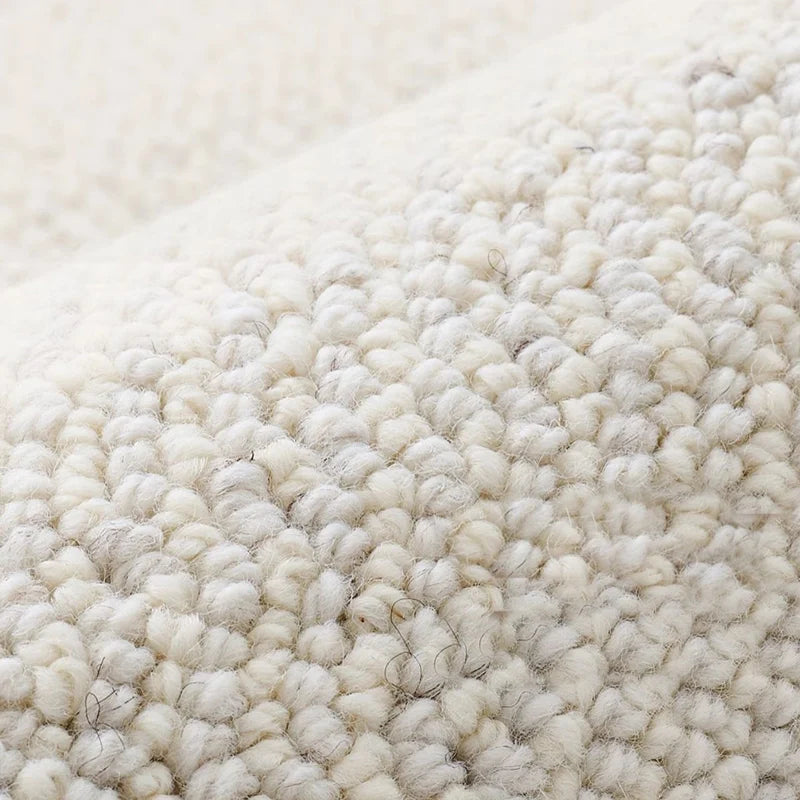 Close-up of dense loop pile wool carpet showcasing natural texture and softness
