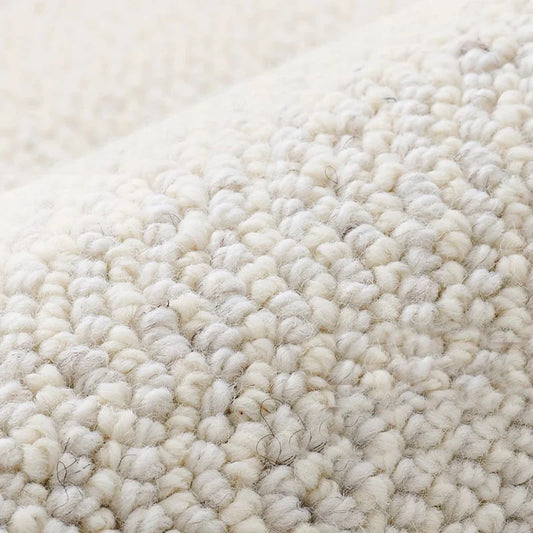 Close-up of dense loop pile wool carpet showcasing natural texture and softness