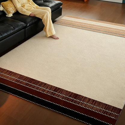 Cream beige border area rug styled with a black sofa and warm brown striped border