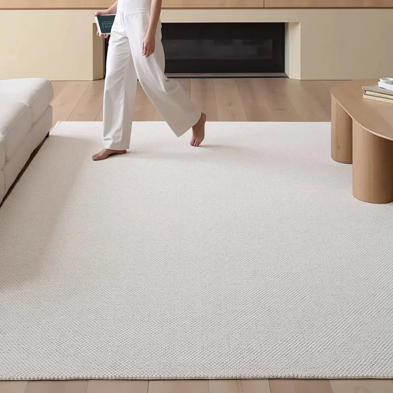 Minimalist wool-blend carpet in light beige, complementing a modern Scandinavian-style living space