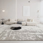 Modern abstract rug in a neutral-toned living room with minimalist furniture and a sleek coffee table #color_white