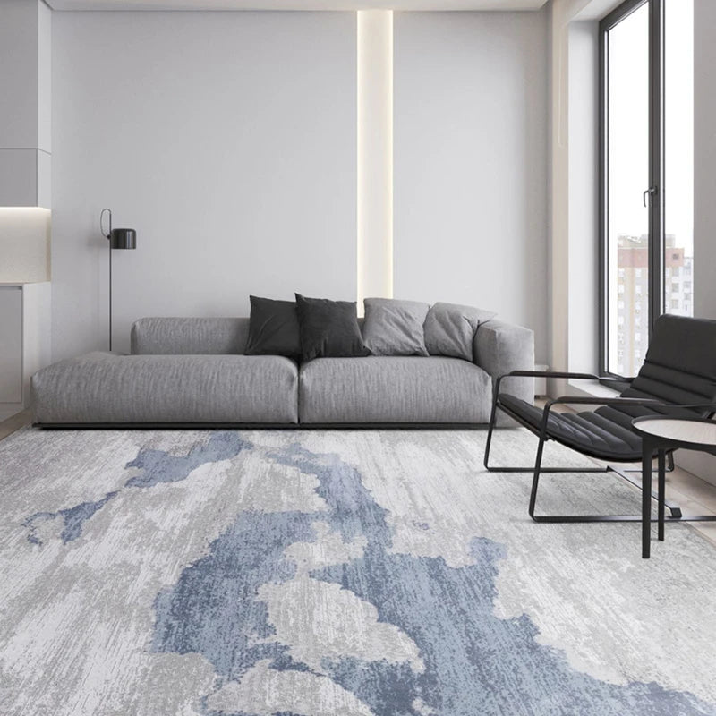 Minimalist living room with a blue-gray abstract rug, creating a soft and serene atmosphere for modern decor #color_blue