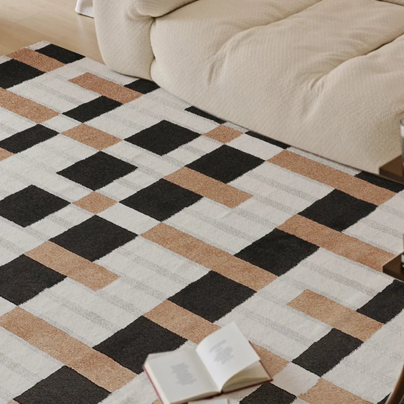 Cozy living space with a modern black, white, and brown checkered rug next to an open book and plush sofa