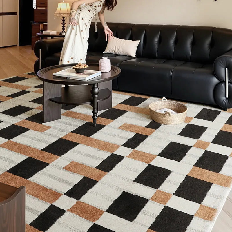 Modern checkered rug with bold geometric pattern in a cozy living room featuring a black leather sofa