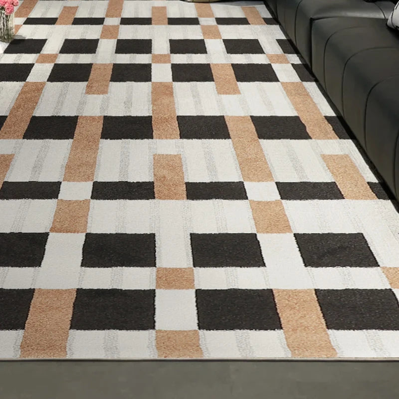 Contemporary checkered area rug with white, brown, and black blocks placed beside a sleek black leather sofa