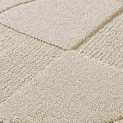 op view of a large geometric rug with 3D circle and square elements in soft cream tones