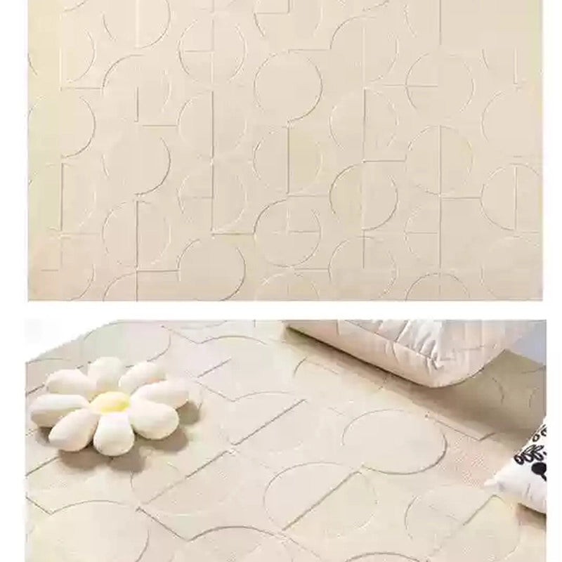 Modern cream rug with circle motifs styled in a cozy living space, highlighting embossed detailing