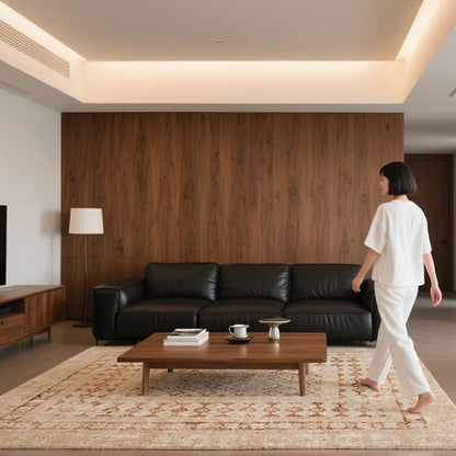Beige tribal patterned rug in a modern living room with wooden wall and black leather sofa