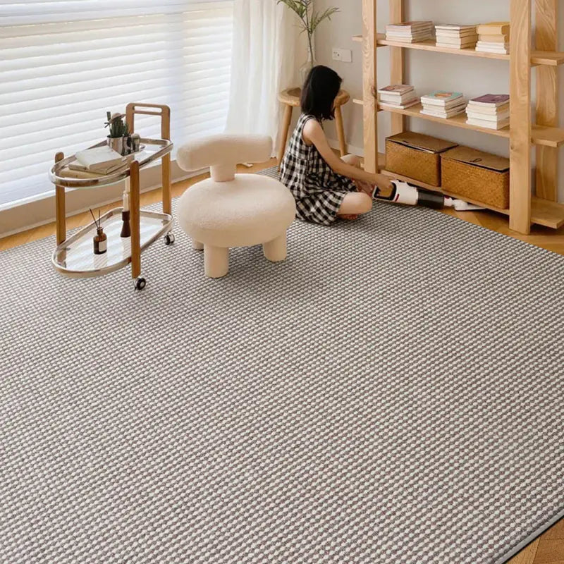 Natural wool blend rug in a bright living room with wooden furniture and soft lighting